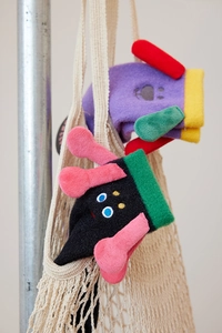 Close-up of cute cartoon plush socks in purple and black soft coral fleece fabric