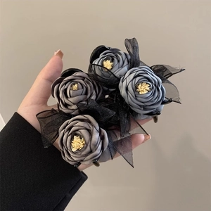 Elegant black hair claw clip with grey-blue fabric roses and delicate ribbon bow