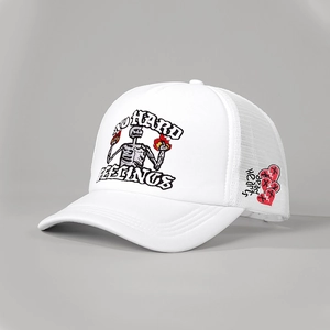 Close-up of heart embroidery and mesh texture on a white trucker baseball cap