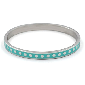 Detail view of silver stainless steel bangle with turquoise enamel and white polka dots