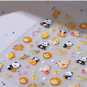 Macro view of 3D embossed panda and rabbit nail art stickers with gold star patterns
