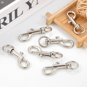 Polished silver swivel spring hooks for DIY keychains and bags displayed on a tray