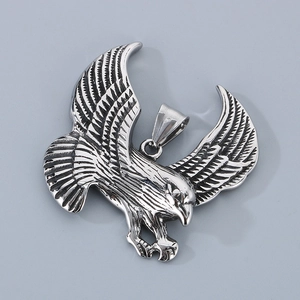 Detailed view of a silver eagle pendant with intricate feather texture and spread wings