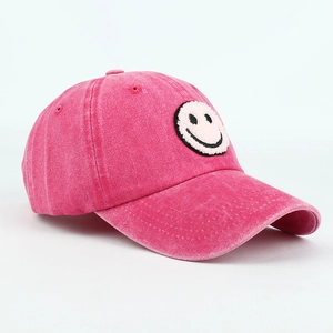 Rose pink washed cotton baseball cap featuring a towel-embroidered smiley face patch
