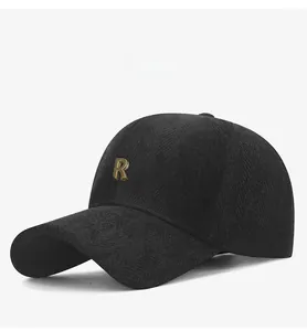 Detailed macro view of the black baseball cap showing herringbone texture and metal R logo