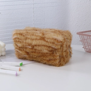Detail of the soft plush pencil case with tiger pattern and metal zipper closure