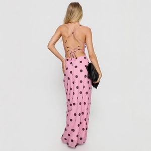 Pink polka dot backless maxi dress with cross strap design for beach vacation style