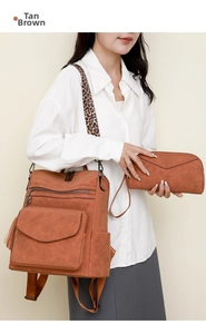 Detail of nubuck brown backpack with tassels, leopard strap and matching clutch