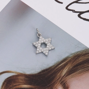Macro detail of a silver hexagram star pendant with sparkling pavé cubic zirconia