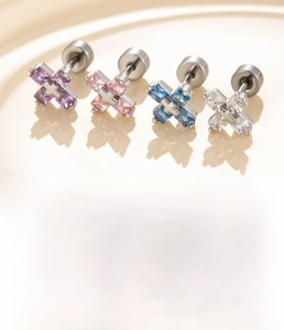 Macro view of cross-shaped zircon earrings in four colors with screw back design