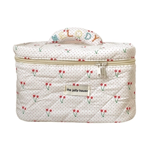 Quilted cotton makeup bag with cherry and polka dot print and rainbow melody handle