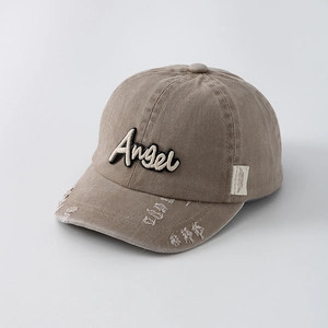 Detail of distressed khaki cotton baseball cap with angel 3D embroidery and frayed edges