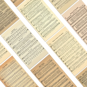 Detailed close-up of vintage English sheet music stickers for scrapbooking and decoration