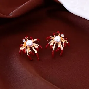 Elegant gold plated fireworks earrings with red enamel petals and white pearls