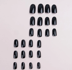 Flat lay of 24 pieces almond-shaped glossy black press-on nails on a beige background