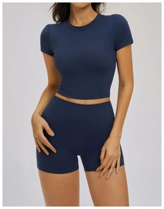 Detail of slim-fit navy yoga set with high-stretch athletic crop top and shorts