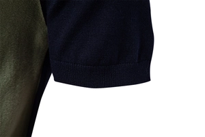 Detail of tight knit texture and ribbed navy cuff on olive green polo shirt