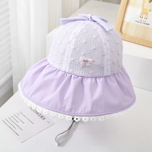 Detail of lavender toddler sun hat with floral lace embroidery and a heart love charm
