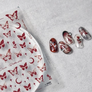 Adesivi per unghie con farfalla rossa e luna scura con esempi di design manicure