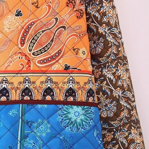 Women's quilted floral jacket with colorful patchwork and paisley patterns in side view