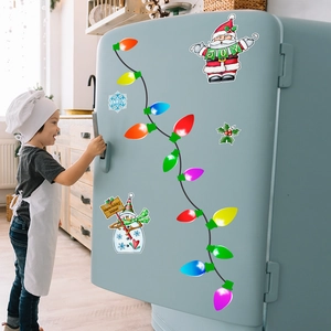 Child placing colorful Santa bulb honeycomb magnetic stickers on a blue retro fridge