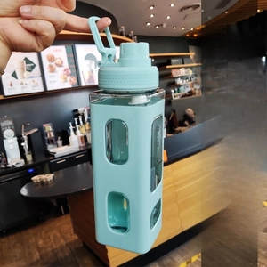 Detail of square sports water bottle with mint green silicone sleeve and large handle