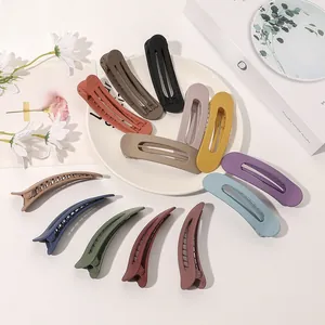 Macro detail of matte Morandi hair clips set in duckbill and oval shapes