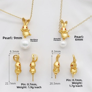 Detailed view of matte gold rabbit pendants with white pearls in two sizes and side profile