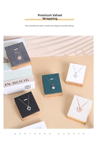 Detail of wooden jewelry display boards with colorful velvet fabric for necklace pendants