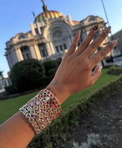 Vue détaillée de bracelets élastiques en zircon avec cœurs et cerises portés sur un poignet