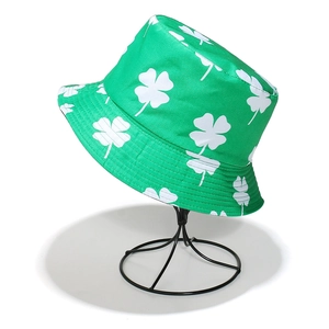Close-up of green bucket hat with white clover print on metal display stand