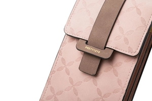 Close-up of pink embossed leather texture with brown buckle detail on a mini mobile bag