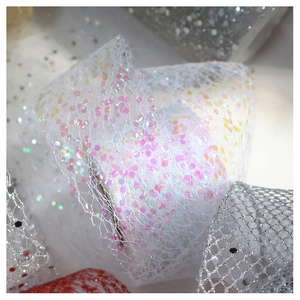 Macro shot of colorful iridescent sequins on high-quality polyester chiffon mesh ribbon