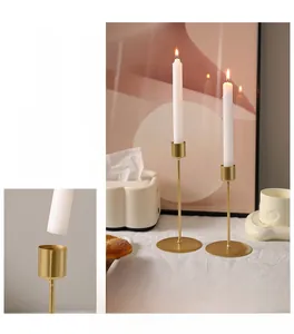 Detail of the golden metal candle holder showing the electroplated finish and circular base