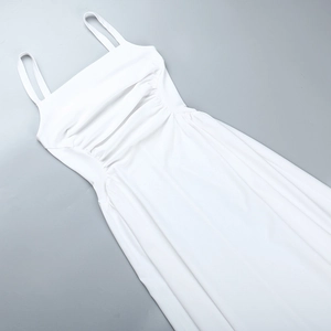 Detailed top view of a white A-line maxi dress with pleated waist and delicate straps