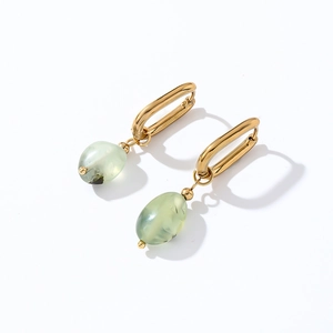 Detail view of light green oval natural stone earrings with polished gold finish