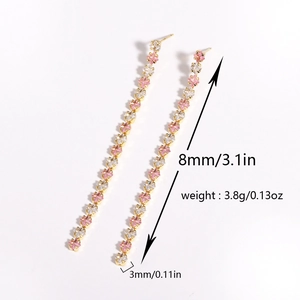 Detail shot of long tassel earrings with pink and white cubic zirconia showing size 3.1 inches
