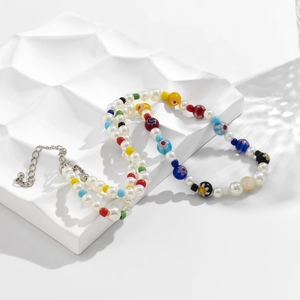 Detail view of pearl and colored glass bead necklace with adjustable metal extender chain