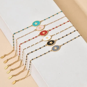 Fashionable stainless steel star bracelets in six colors on stone steps display