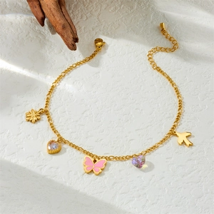 Gold stainless steel anklet with pink butterfly flower and bird charms on white background