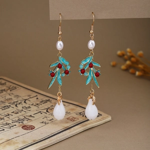 Detail of New Chinese style butterfly earrings with white pearls and turquoise glaze finish