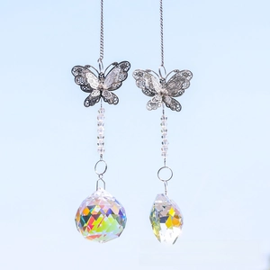 Detail of hanging butterfly suncatchers with multifaceted crystal prisms and metal chains