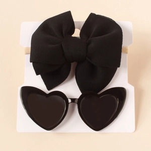 Detail of black bow nylon headband and heart-shaped sunglasses set for babies