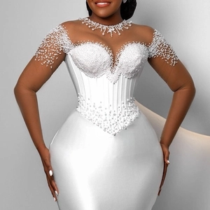Elegant white satin mermaid wedding dress featuring ornate pearl beading and a corset bodice