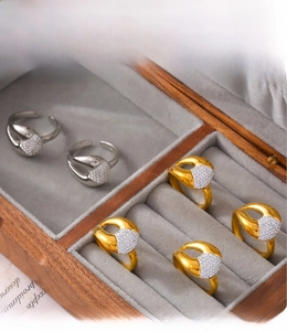 Detailed close-up of gold and silver PVD plated irregular rings with cubic zirconia