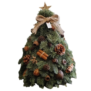 Mini DIY faux Christmas tree tabletop decor with pine cones, cinnamon and wooden base