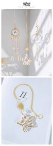 Detail of star and moon crystal suncatchers with gold metal chains for home window decor