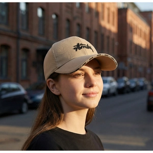 Detail of khaki cotton baseball cap with black letter embroidery and sport brim strap