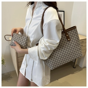 Detailed view of brown tote bag set featuring vintage pattern and leather accents