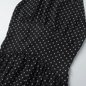 Detail of high waist pleated design and polka dot pattern on summer backless maxi dress